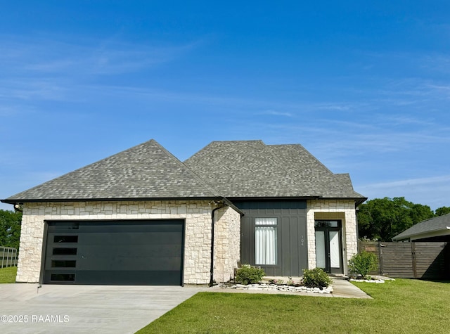 104 Cherrywood Dr, Lafayette, LA 70508 - view of front of home featuring an attached garage, concrete driveway, roof with shingles, board and batten siding, and stone siding
