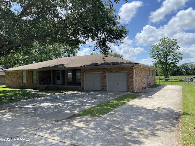 single story home featuring an attached garage, fence, brick siding, and concrete driveway