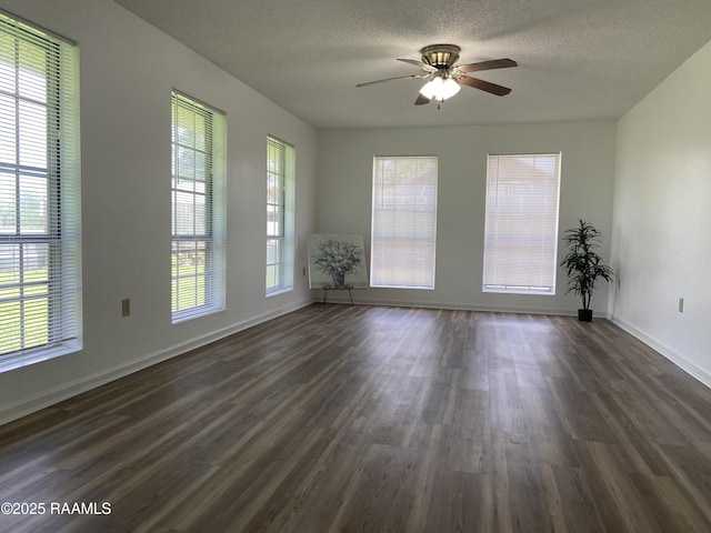 unfurnished room featuring baseboards, a textured ceiling, ceiling fan, and dark wood-style floors