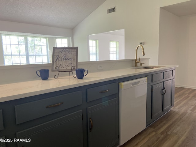 kitchen featuring dark wood-style flooring, white dishwasher, a sink, lofted ceiling, and visible vents
