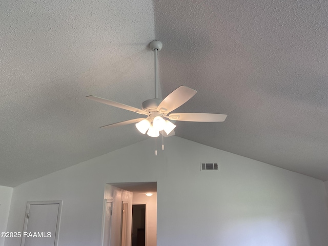 interior details featuring a textured ceiling, ceiling fan, and visible vents