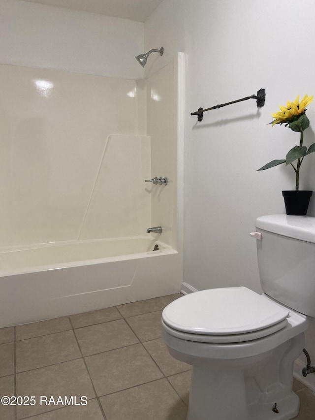 full bath featuring shower / bath combination, tile patterned flooring, and toilet