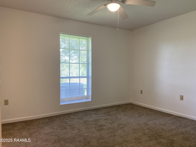 unfurnished room with baseboards, carpet flooring, and a ceiling fan