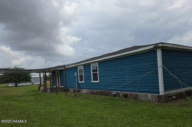 view of side of property with a yard