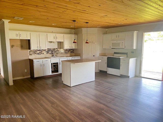 428 Nonc Lol Dr, Arnaudville, LA 70512 - kitchen featuring a kitchen island, a sink, wooden ceiling, white microwave, and electric stove