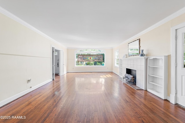 unfurnished living room featuring a fireplace, wood finished floors, ornamental molding, and baseboards
