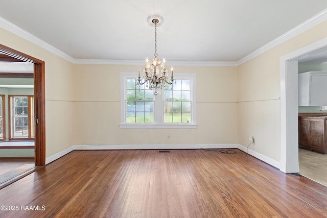 unfurnished dining area with an inviting chandelier, wood finished floors, ornamental molding, and baseboards