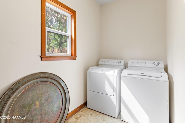 laundry room with washing machine and clothes dryer, laundry area, and baseboards
