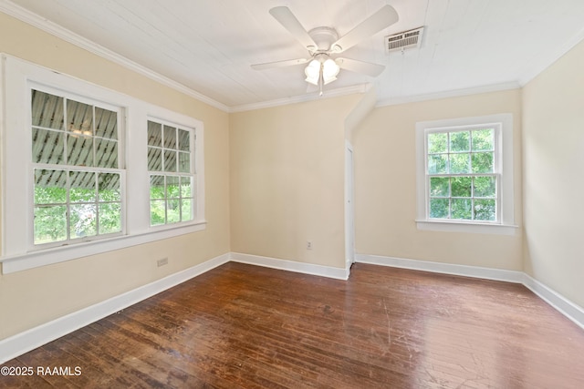 empty room with crown molding, baseboards, visible vents, a ceiling fan, and dark wood-type flooring