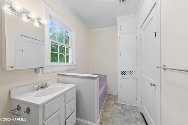 bathroom with vanity, a bath, visible vents, baseboards, and ornamental molding