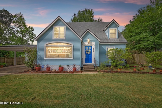 view of front of house with fence, entry steps, and a front lawn