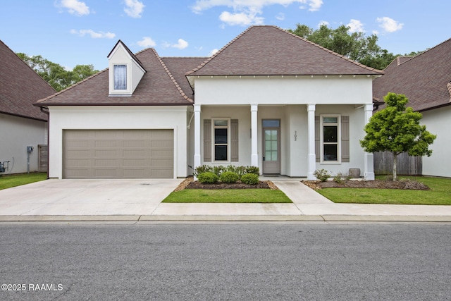 102 Drifting Sands Ln, Lafayette, LA 70503 - view of front facade featuring fence, concrete driveway, an attached garage, stucco siding, and a porch
