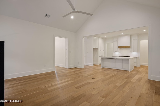 102 Drifting Sands Ln, Lafayette, LA 70503 - unfurnished living room with visible vents, baseboards, light wood finished floors, a ceiling fan, and high vaulted ceiling