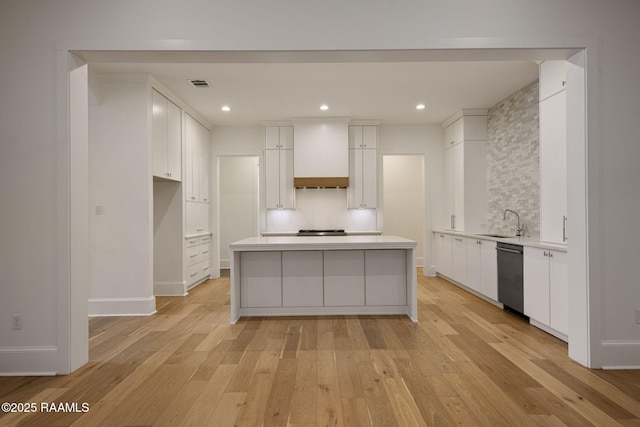 102 Drifting Sands Ln, Lafayette, LA 70503 - kitchen featuring custom range hood, light wood-style floors, appliances with stainless steel finishes, white cabinets, and a sink