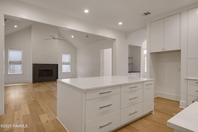 102 Drifting Sands Ln, Lafayette, LA 70503 - kitchen featuring recessed lighting, light wood-style flooring, white cabinets, ceiling fan, and a fireplace