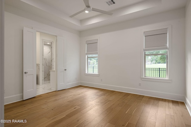 102 Drifting Sands Ln, Lafayette, LA 70503 - unfurnished bedroom with hardwood / wood-style flooring, a raised ceiling, visible vents, baseboards, and ensuite bath
