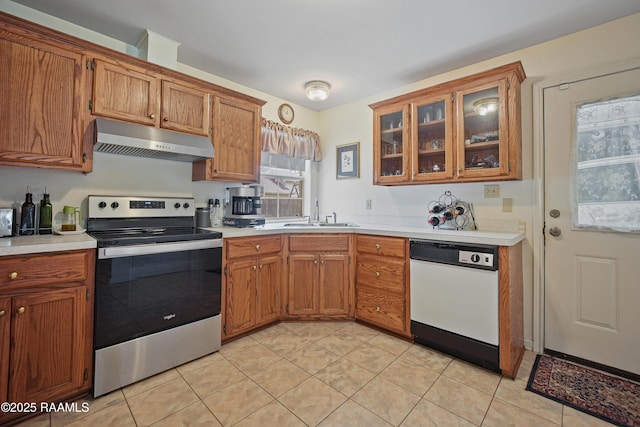 kitchen featuring a sink, under cabinet range hood, white dishwasher, stainless steel electric range oven, and light countertops