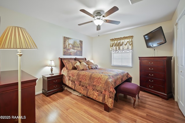 bedroom with ceiling fan, light wood-type flooring, and baseboards