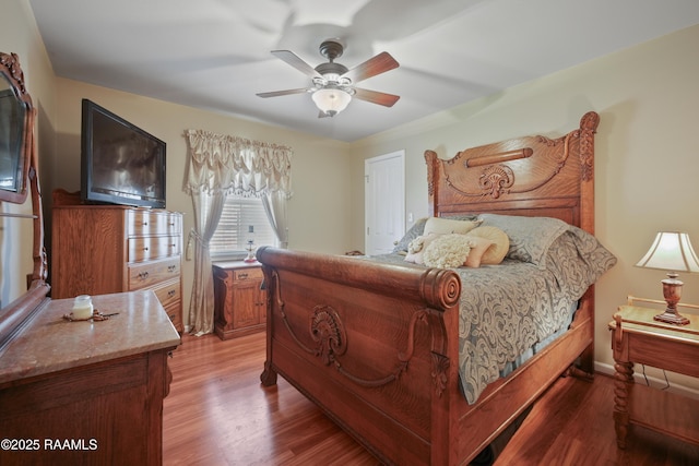 bedroom with a ceiling fan and wood finished floors