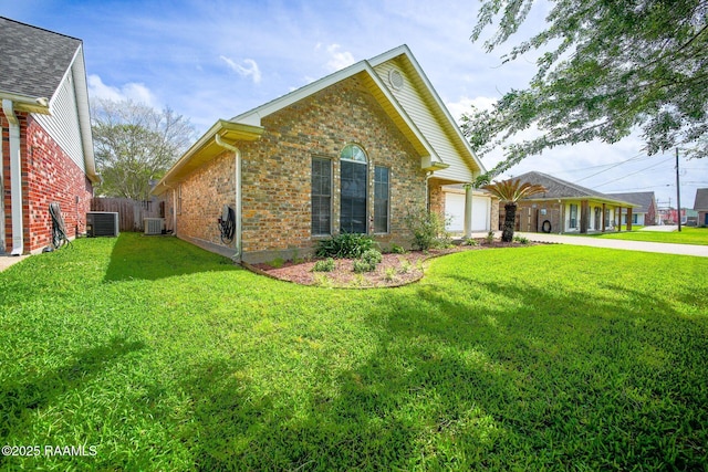 exterior space with brick siding, a garage, central AC unit, driveway, and a lawn