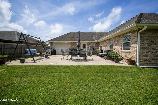 exterior space featuring fence, grilling area, and an attached garage