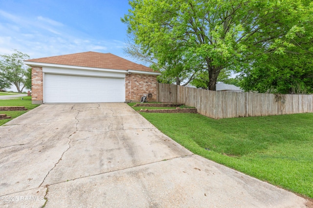 view of front of house with brick siding, fence, a garage, a front lawn, and concrete driveway