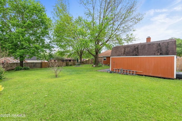 view of yard featuring an outbuilding and a fenced backyard