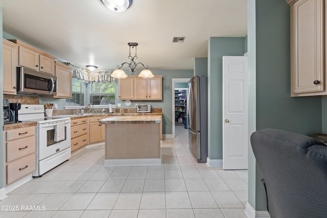 kitchen with appliances with stainless steel finishes, visible vents, and light brown cabinets