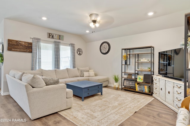 living area with wood finished floors, a ceiling fan, and baseboards