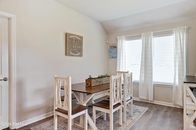 dining area with lofted ceiling, wood finished floors, plenty of natural light, and baseboards