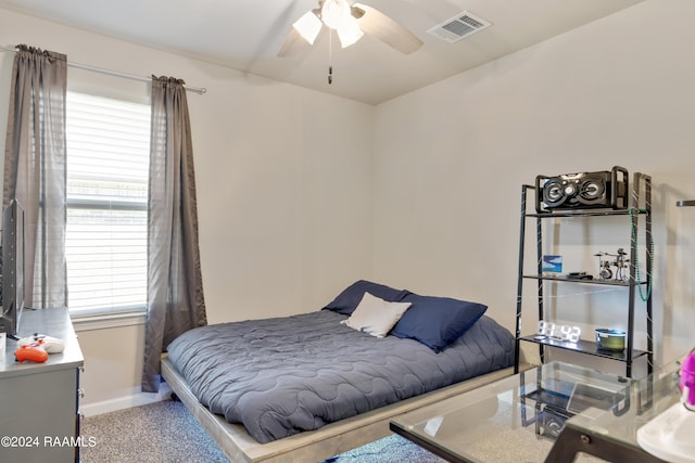 bedroom with visible vents, ceiling fan, baseboards, and multiple windows