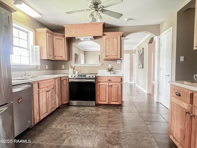 707 W Pine St, Erath, LA 70533 - kitchen featuring stainless steel appliances, a sink, a ceiling fan, light countertops, and arched walkways