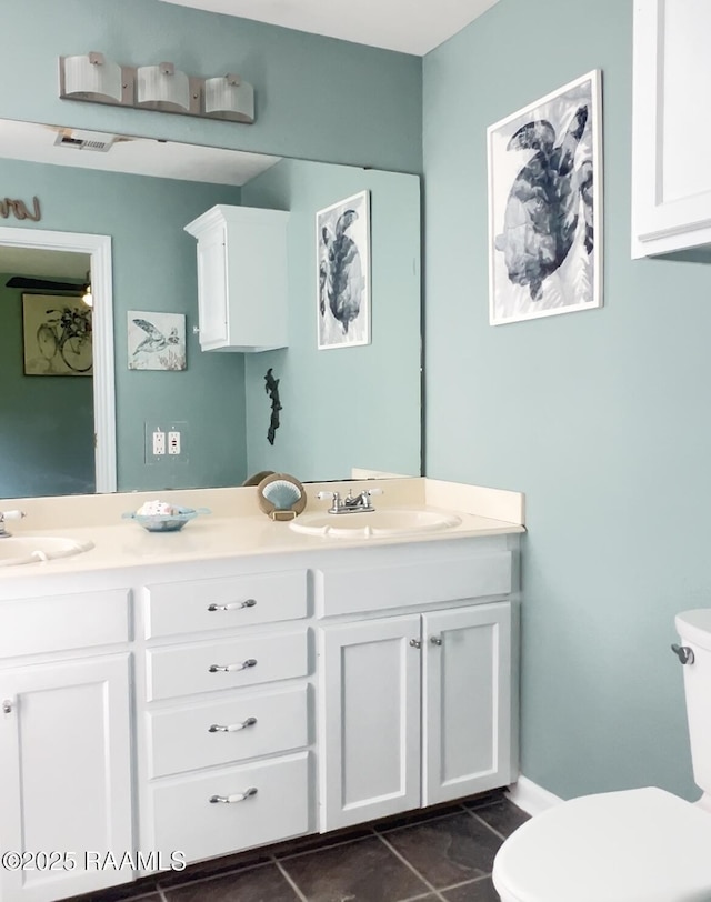 707 W Pine St, Erath, LA 70533 - bathroom with double vanity, toilet, and tile patterned flooring