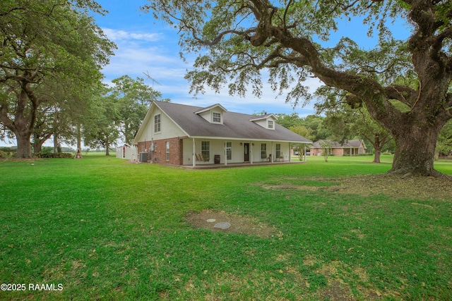 111 W Oaklawn Dr, Franklin, LA 70538 - view of front facade featuring a porch, brick siding, central AC unit, and a front lawn