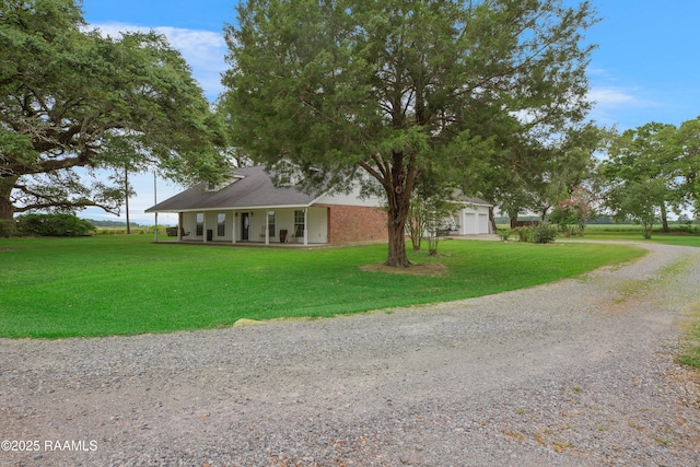 111 W Oaklawn Dr, Franklin, LA 70538 - farmhouse with an attached garage, a porch, driveway, and a front yard