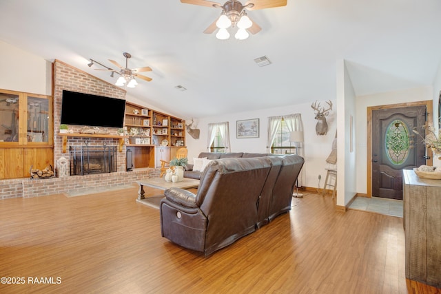 111 W Oaklawn Dr, Franklin, LA 70538 - living area with ceiling fan, built in features, wood finished floors, lofted ceiling, and visible vents