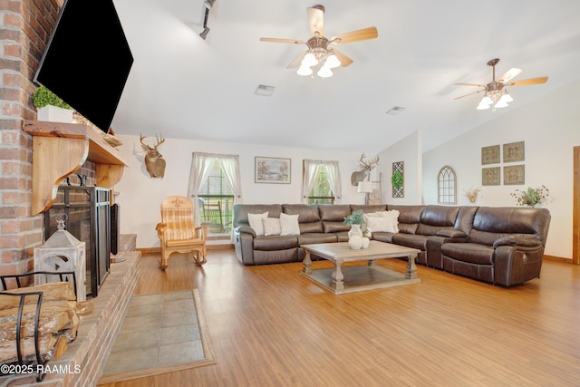 111 W Oaklawn Dr, Franklin, LA 70538 - living room featuring a ceiling fan, visible vents, wood finished floors, and a wood stove