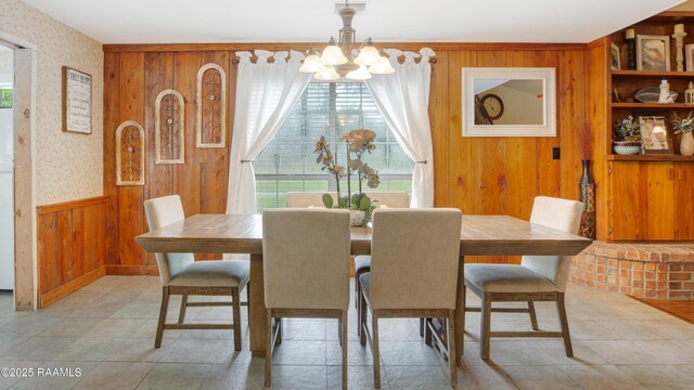 111 W Oaklawn Dr, Franklin, LA 70538 - dining area with wainscoting, a notable chandelier, wooden walls, and wallpapered walls