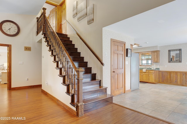 111 W Oaklawn Dr, Franklin, LA 70538 - stairs featuring baseboards, wallpapered walls, and wood finished floors