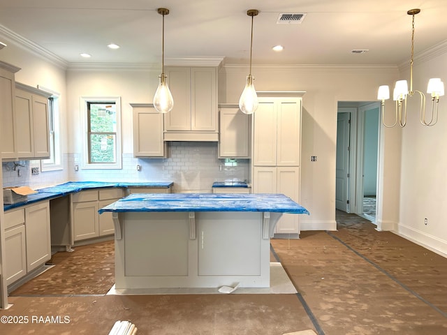 111 Fillmore Way, Lafayette, LA 70506 - kitchen featuring decorative backsplash, a chandelier, a kitchen island, pendant lighting, and ornamental molding
