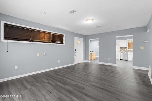 unfurnished living room with baseboards and dark wood-style flooring