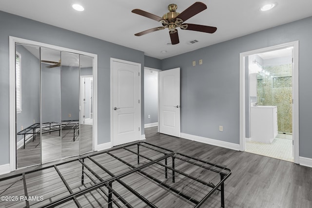 unfurnished bedroom featuring recessed lighting, baseboards, visible vents, and wood finished floors