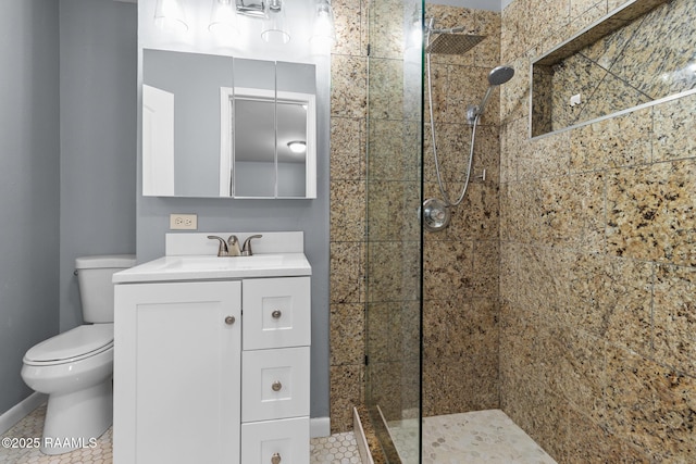 bathroom with walk in shower, vanity, toilet, tile patterned floors, and baseboards