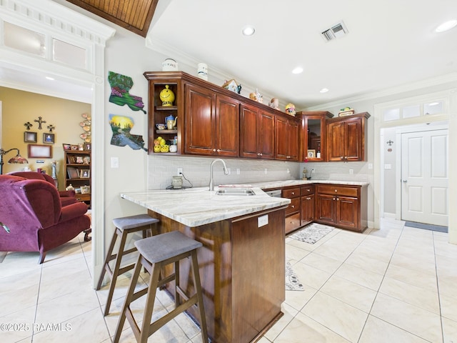 124 Vestige Cir, Lafayette, LA 70508 - kitchen featuring a sink, light tile patterned flooring, visible vents, a peninsula, and ornamental molding