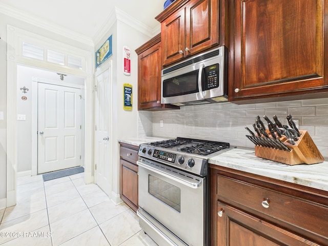 124 Vestige Cir, Lafayette, LA 70508 - kitchen with light stone counters, light tile patterned floors, tasteful backsplash, crown molding, and appliances with stainless steel finishes