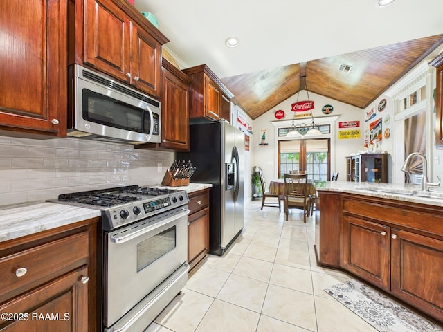 124 Vestige Cir, Lafayette, LA 70508 - kitchen featuring a sink, appliances with stainless steel finishes, light tile patterned flooring, vaulted ceiling, and backsplash