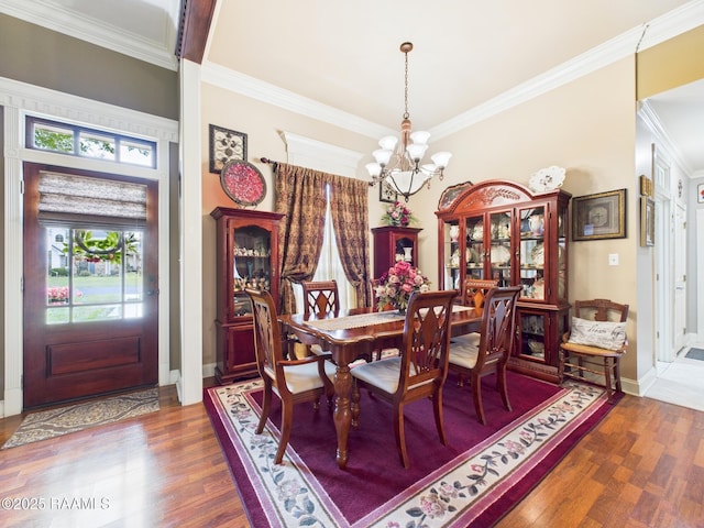 124 Vestige Cir, Lafayette, LA 70508 - dining area featuring a chandelier, baseboards, wood finished floors, and crown molding