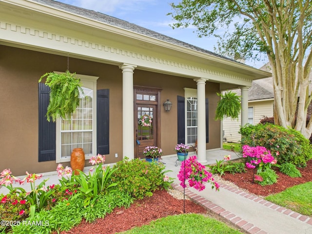 124 Vestige Cir, Lafayette, LA 70508 - doorway to property with stucco siding, roof with shingles, and covered porch