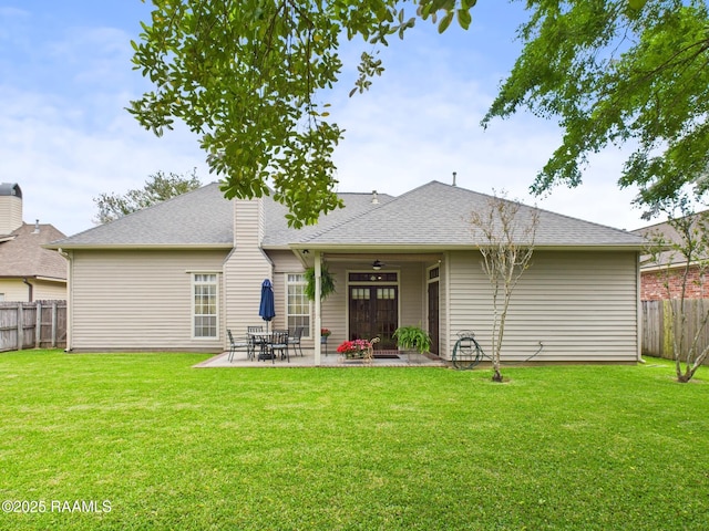 124 Vestige Cir, Lafayette, LA 70508 - rear view of house with a patio, a fenced backyard, a yard, and roof with shingles
