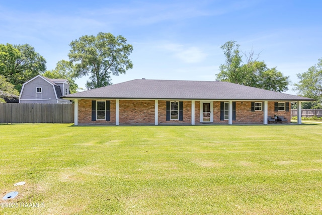 view of front of home with a porch, a front yard, and fence